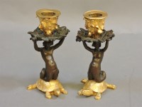 Lot 217 - A pair of bronze candlesticks