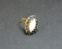 Lot 27 - A 9ct gold marquise shaped opal and sapphire cluster ring