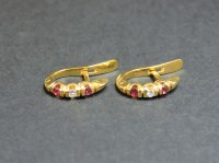 Lot 38 - A pair of 18ct gold ruby and diamond hinged hoop earrings
