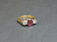Lot 1 - An 18ct gold ruby and diamond three stone ring