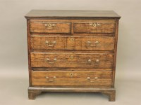 Lot 677 - An oak chest of two over three drawers