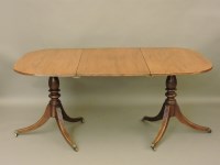 Lot 747 - A twin pillar mahogany dining table