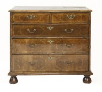 Lot 632 - A walnut chest of two short and three long drawers