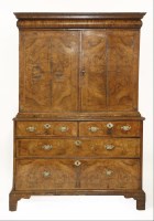 Lot 634 - A walnut cabinet on chest