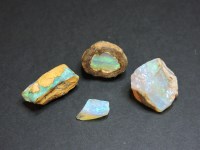 Lot 39 - A collection of four uncut opal/boulder opals