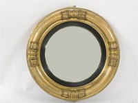 Lot 653 - A Regency circular convex wall mirror