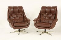 Lot 535 - A pair of brown leather armchairs