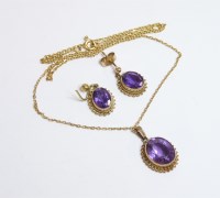Lot 51 - An amethyst pendant and earring suite