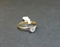 Lot 3 - A 9ct yellow and white gold single stone diamond crossover ring