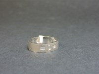 Lot 16 - An 18ct white gold flat section wedding ring