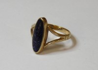 Lot 12 - A 9ct gold dark blue synthetic goldstone ring