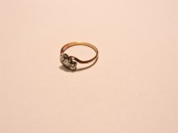 Lot 57 - A three stone diamond crossover ring