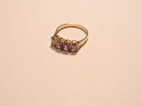 Lot 59 - A 9ct gold four stone amethyst ring