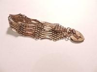 Lot 72 - An Edwardian six row gold gate bracelet