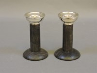 Lot 209 - A pair of miniature ebony candlesticks