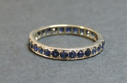 Lot 60 - An 18ct white gold sapphire full eternity ring