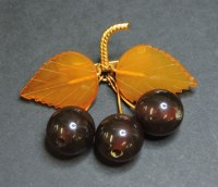 Lot 43 - A gold plated bakelite cherry brooch
