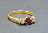 Lot 52 - An 18ct gold three stone ruby and diamond ring