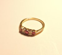 Lot 169 - An 18ct gold three stone ruby ring