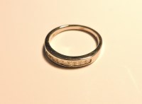 Lot 183 - An 18ct white gold princess cut diamond channel set half eternity ring