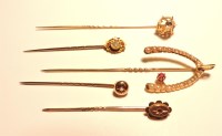 Lot 198 - A ruby and split pearl wishbone stick pin