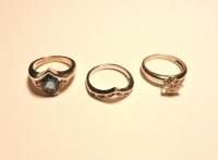 Lot 222 - A 9ct white gold three stone blue topaz and diamond wishbone ring