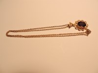 Lot 282 - An amethyst and split pearl gold pendant