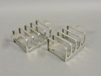 Lot 457 - A matched pair of small silver toast racks