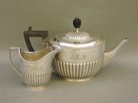 Lot 482 - A silver teapot and milk jug