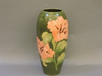 Lot 556 - A large Moorcroft coral Hibiscus pattern vase