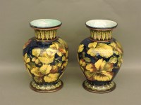 Lot 651 - A pair of Royal Doulton faience vases