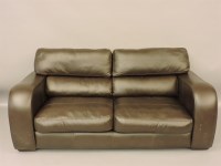 Lot 887 - A brown leather settee