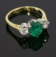 Lot 582 - An emerald and diamond three stone ring