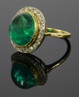 Lot 454 - An emerald and diamond oval cluster ring