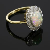 Lot 534 - An opal and diamond oval cluster ring