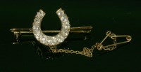 Lot 365 - A late Victorian diamond set horseshoe bar brooch