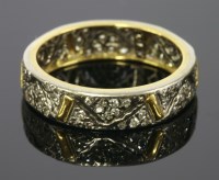 Lot 614 - A white and yellow gold diamond set band ring