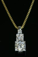 Lot 603 - A yellow and white gold three stone diamond pendant