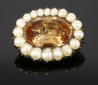 Lot 319 - A Georgian topaz and split pearl gold brooch