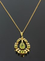 Lot 394 - An Edwardian peridot and split pearl gold pendant