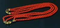 Lot 499 - A two row uniform coral bead necklace