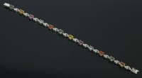 Lot 596 - An 18ct white gold multicoloured sapphire and diamond line bracelet