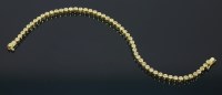 Lot 616 - An 18ct gold diamond set line bracelet