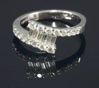 Lot 654 - An 18ct white gold diamond set crossover ring