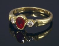 Lot 674 - An 18ct gold ruby and diamond three stone ring