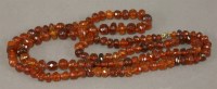 Lot 1079 - A single row faceted amber bead necklace