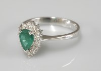 Lot 1015 - An 18ct white gold pear shaped emerald and diamond cluster ring