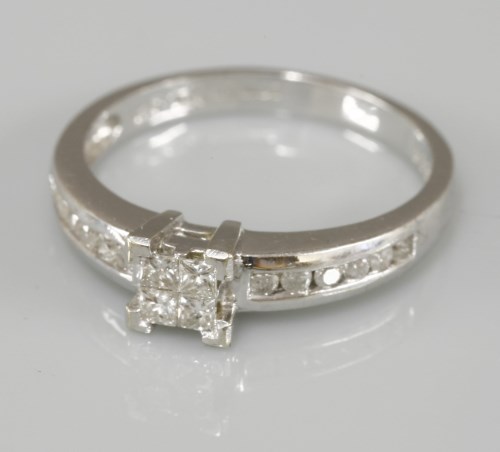 Lot 1003 - A 9ct white gold four stone princess cut diamond invisibly set ring