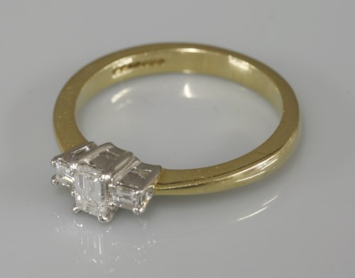 Lot 1011 - An 18ct gold single stone emerald cut diamond ring