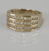 Lot 1047 - A 9ct gold three row channel set diamond ring
